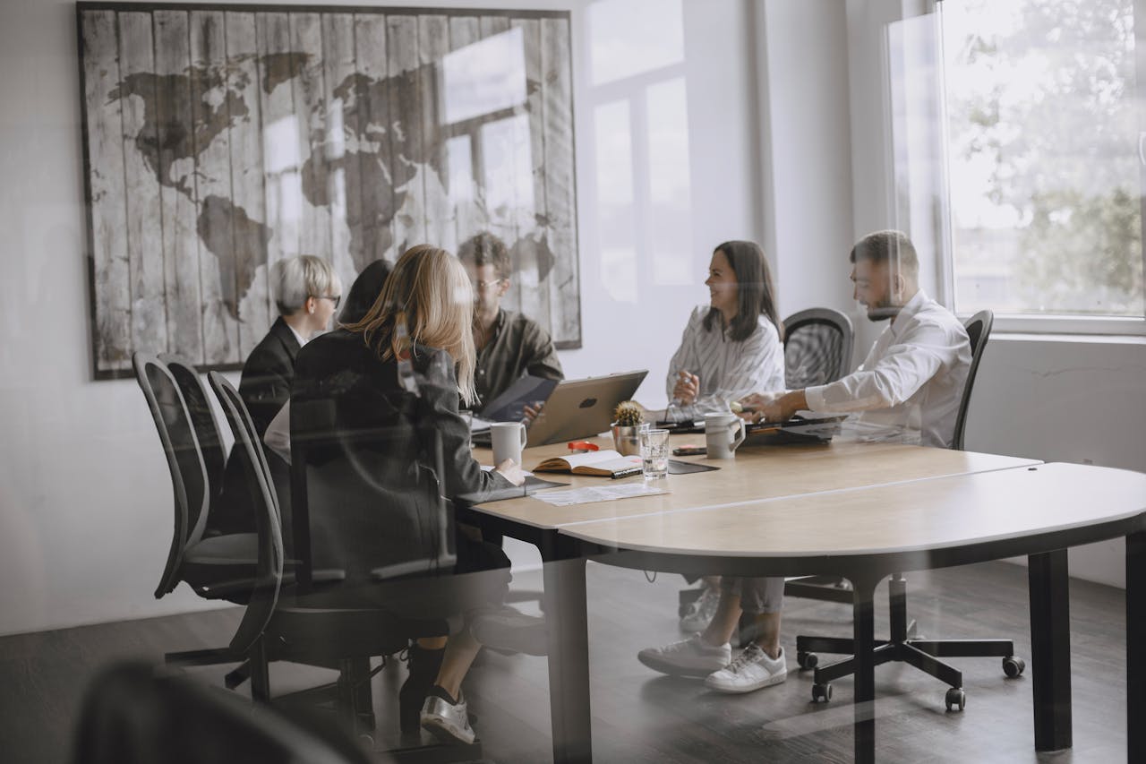 A diverse group of colleagues in a meeting in a modern office setting.